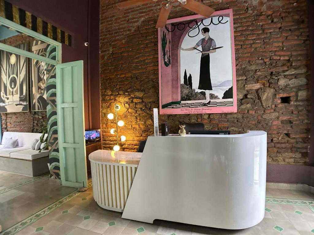 a room with a white table and a picture on the wall at Casa Verde Hotel in Santa Marta