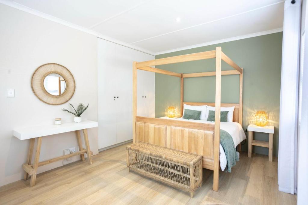 a bedroom with a canopy bed with a mirror at Hilton House One in Hilton