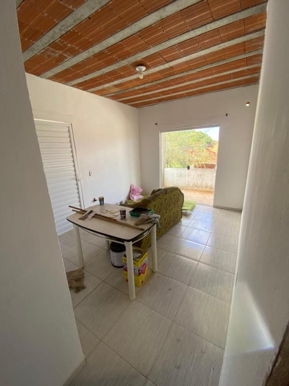 a living room with a table and a couch at Casa Praia do Gaviao in Araruama