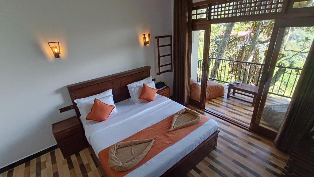 a bedroom with a bed and a large window at Ameliora Hotel Ella in Ella