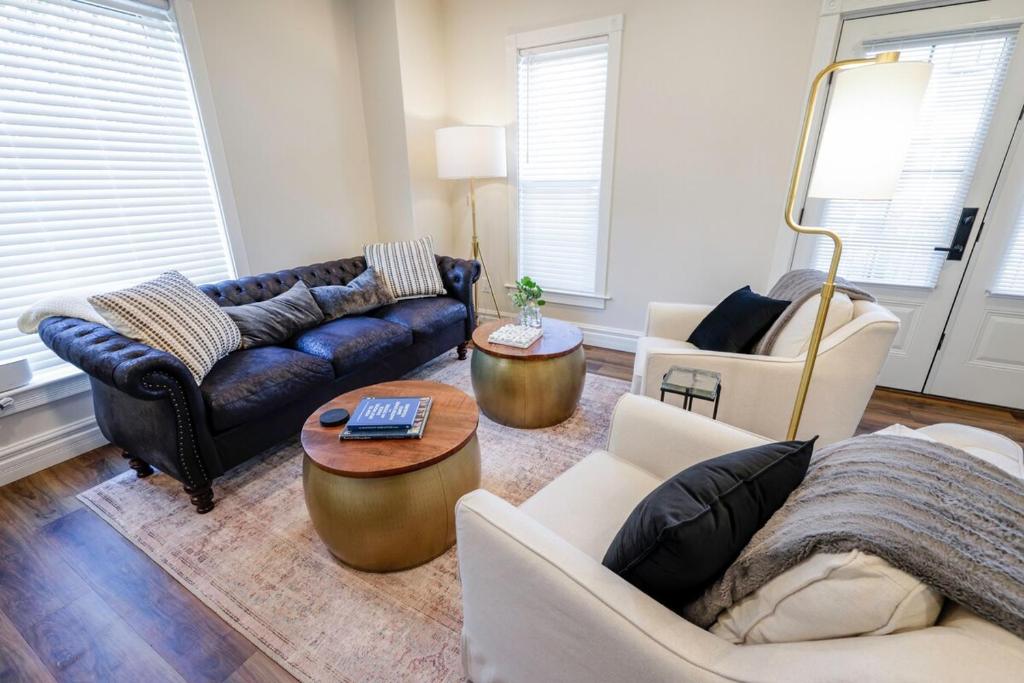 a living room with two couches and a table at Eliza Gothic in Maquoketa