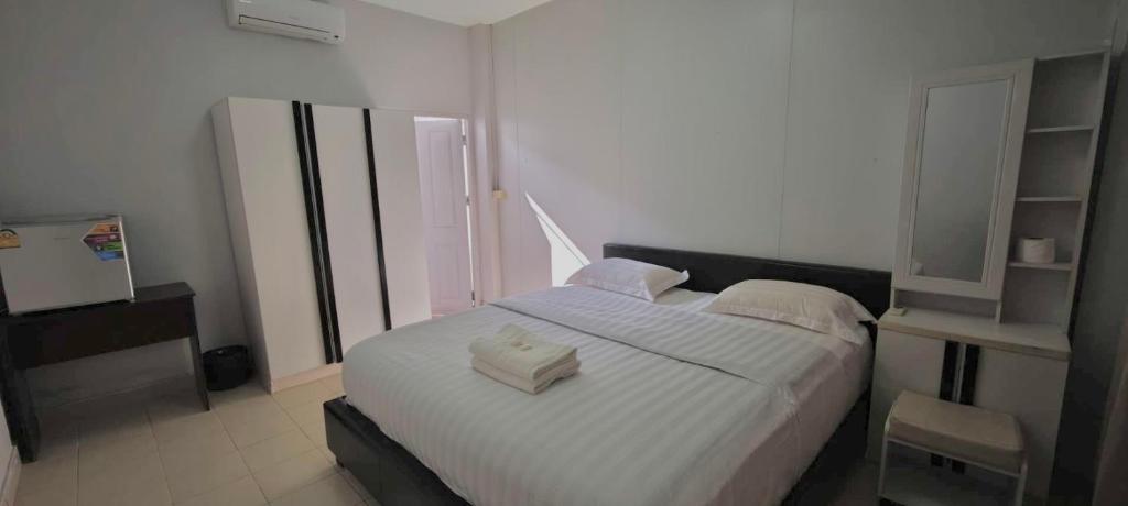 a bedroom with a large white bed with two pillows at Nong Lom Grand in Loei
