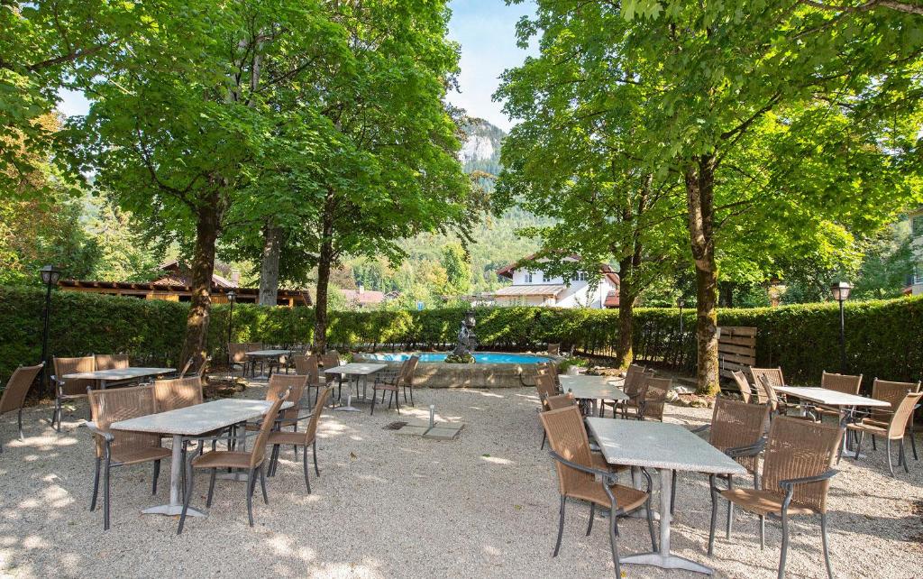 a patio with tables and chairs and a fountain at ciao-aschau Haus zur Burg Apn220 Mina in Aschau