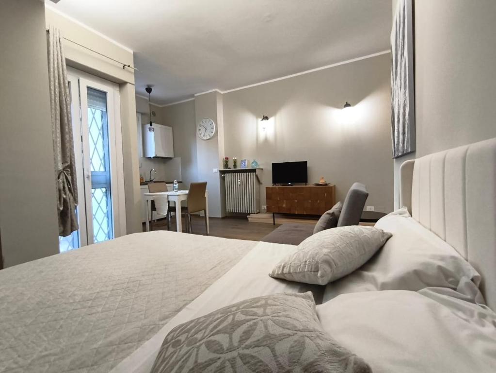 a bedroom with a large bed and a dining room at Casa Piera in Turin