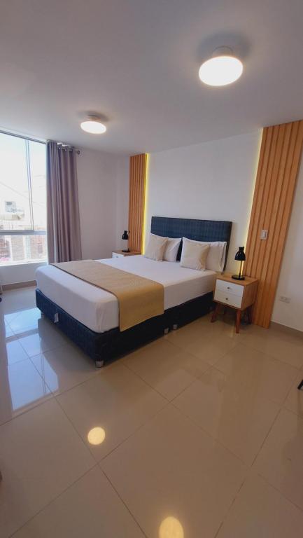 a bedroom with a large bed in a room at Mandala Lux Hotel in Pisco