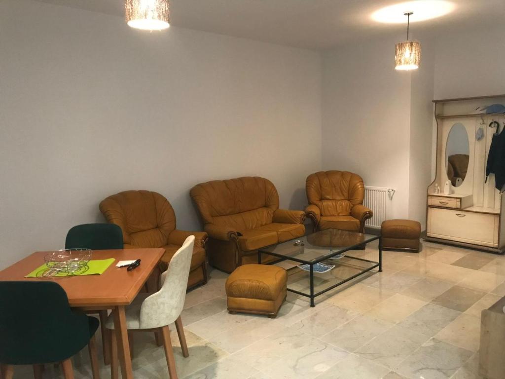 a living room with chairs and a table and a dining room at Dar Nouri in Hammamet