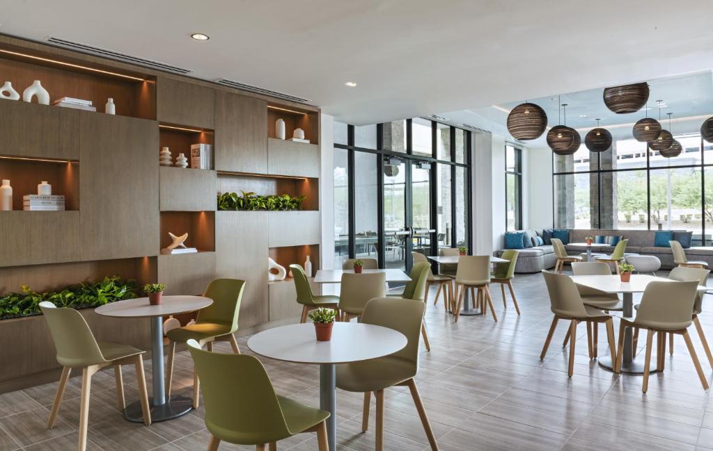a restaurant with tables and chairs and windows at Element Las Vegas Symphony Park in Las Vegas