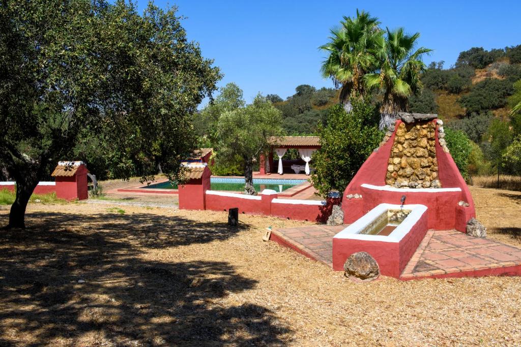 a playground with a fountain in a park at Villa Rural Las Encinas in Alosno