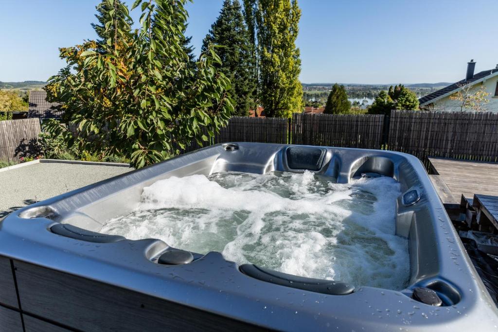 a jacuzzi tub with snow in a backyard at Bergerie bien être in Vaivre-et-Montoille