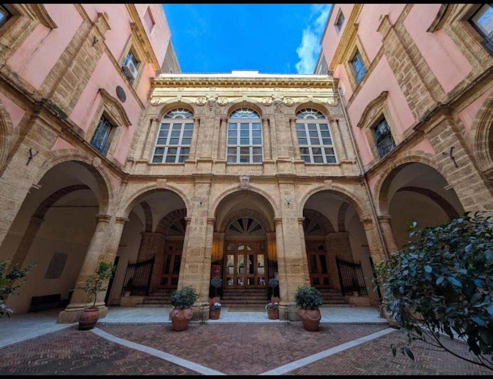 a large building with large arches and windows at Cuore di Agrigento Home in Agrigento