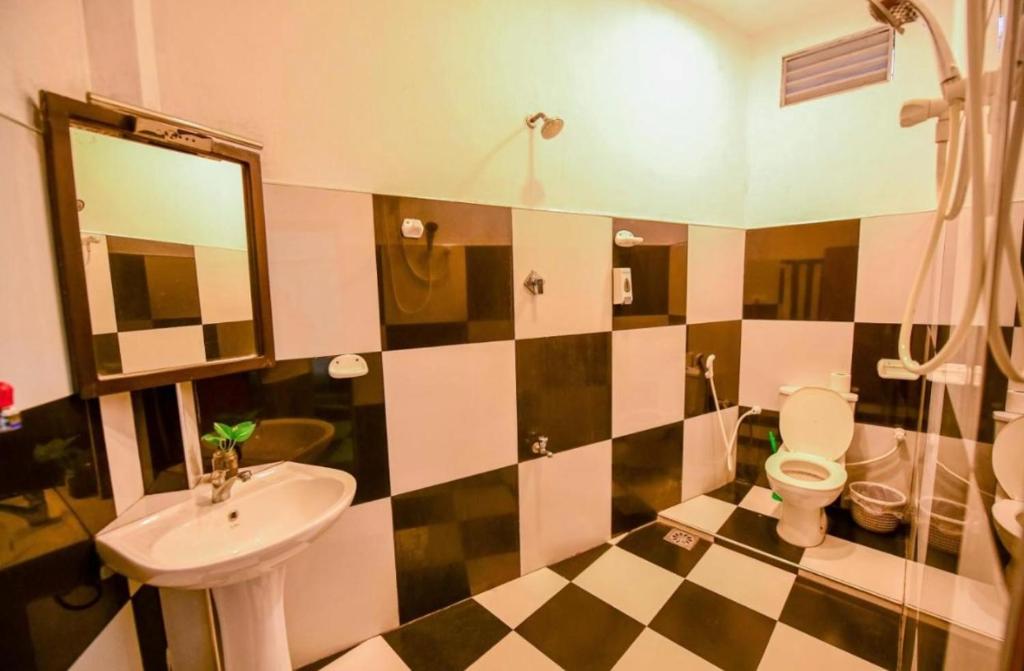 a bathroom with a sink and a toilet at KAIMANA HOUSE - 3 Min walk to the beaches in Tangalle