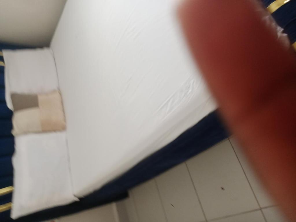 a person is pointing at a piece of paper at Buxton Point Kandy Classy Two Bedroom Apartment in Mombasa