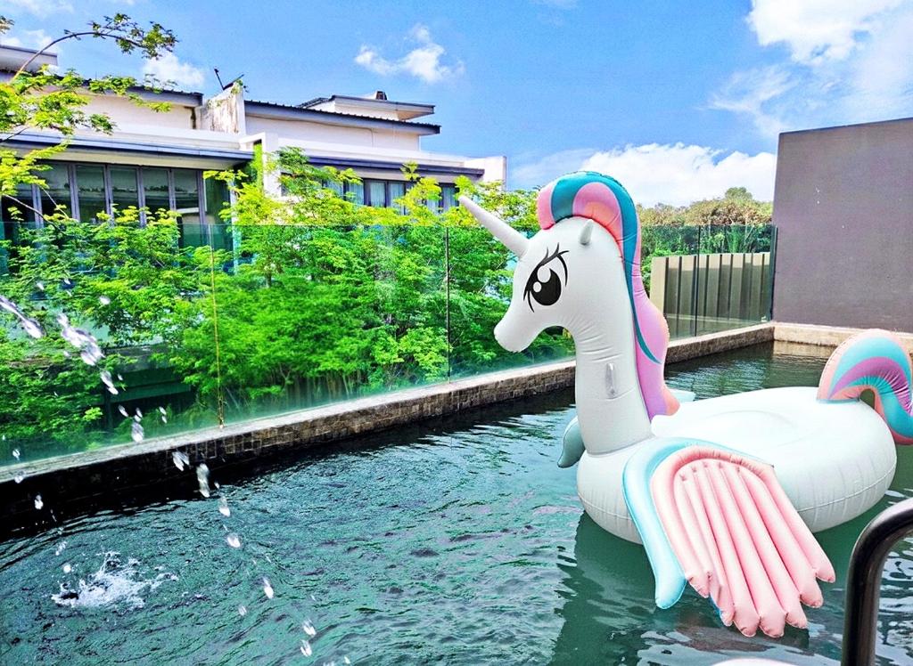 a pool with a unicorn float in the water at Cyberjaya Puchong JWJ Pool Villa in Cyberjaya
