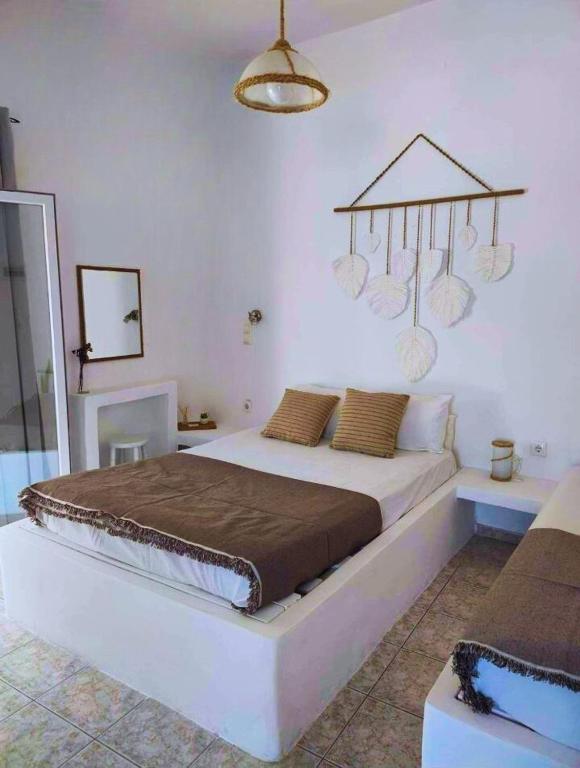 a bedroom with a large bed in a room at Venetos Studios in Livadi Astypalaias