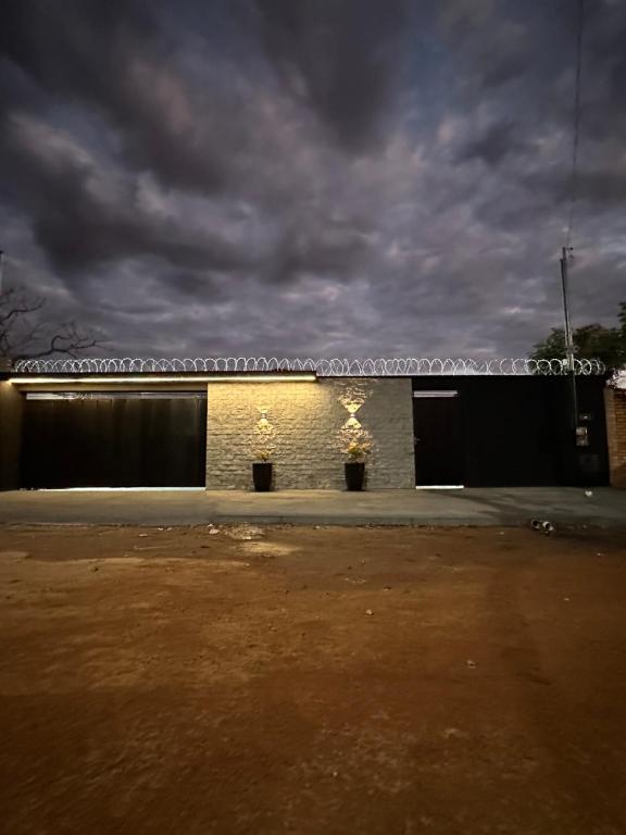 a building with two garage doors and a cloudy sky at Aruanã - Casa Sol in Aruanã in Aruanã