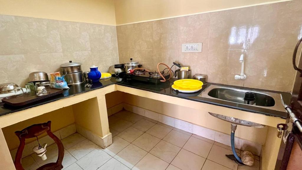 a kitchen with a sink and a counter top at Jungle retreat waterfalls in Kodaikānāl