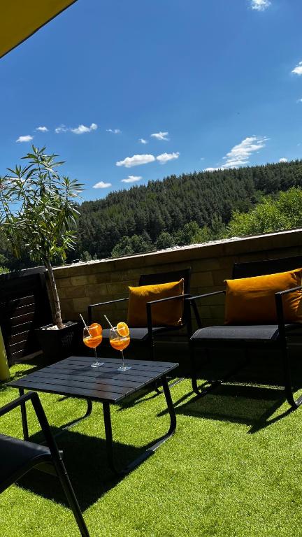a patio with a table and two glasses on it at Casa Lara Apartman in Egerszalók