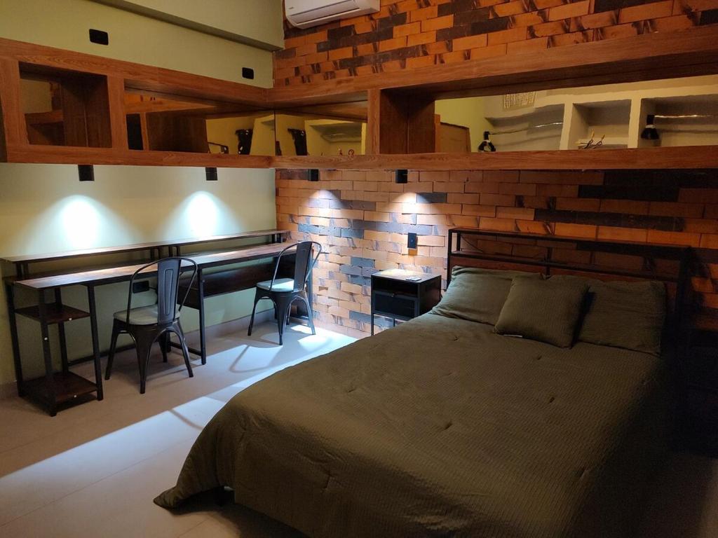 a bedroom with a bed and a table and a desk at Amber Apartment at Downtown in Chihuahua