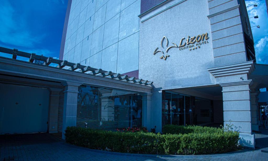 a building with a sign on the side of it at Lizon Curitiba Hotel in Curitiba