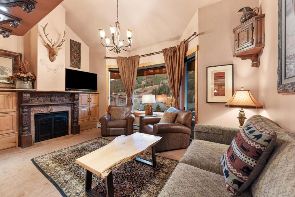 a living room with a couch and a fireplace at Telemark Lodge #504 in Copper Mountain