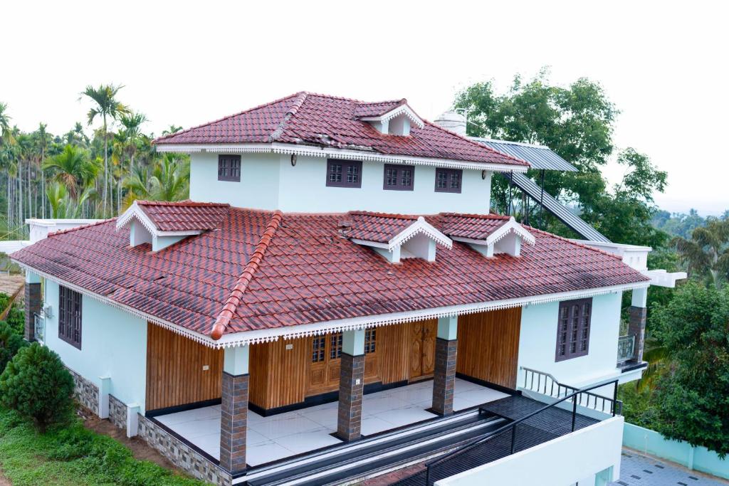 an overhead view of a house with a red roof at Wayanad Midnight Oasis in Meenangadi