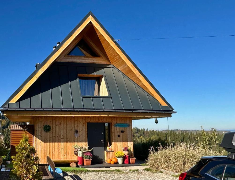 a small house with a gambrel roof at Domek Tatry - Stacja Wierchowa 972 m in Brzegi