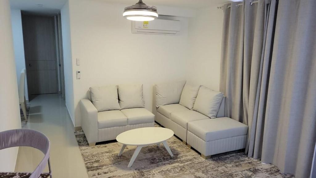 a living room with a couch and a table at Centro Historico Barranquilla New 3BR Apt w Pool in Barranquilla