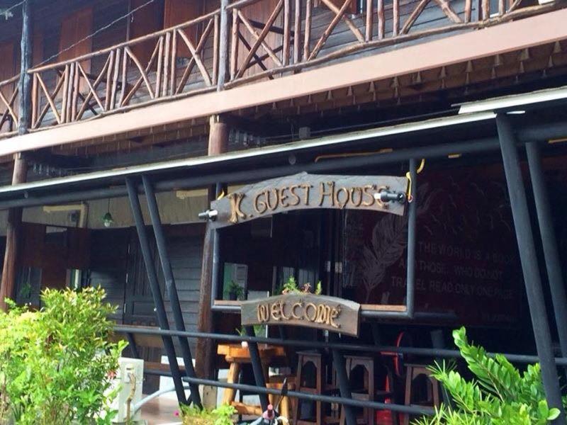 a restaurant with a sign on the front of a building at K Guesthouse Adults only in Krabi