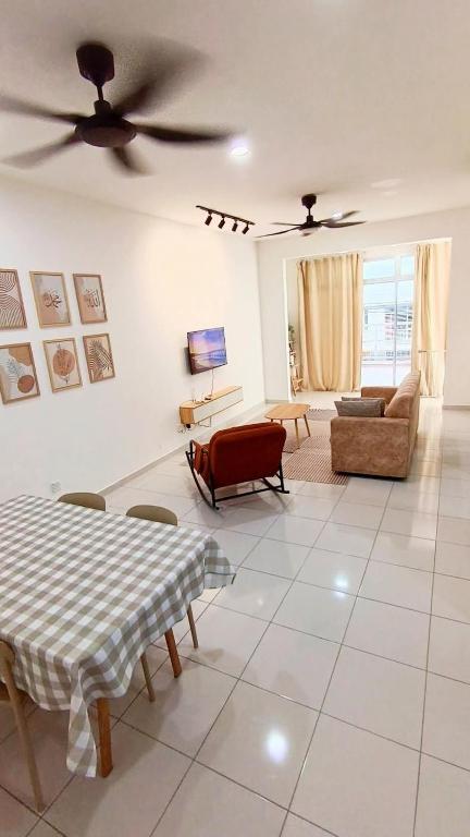 a living room with a couch and a ceiling fan at Townixi Stay in Kampong Jelatang