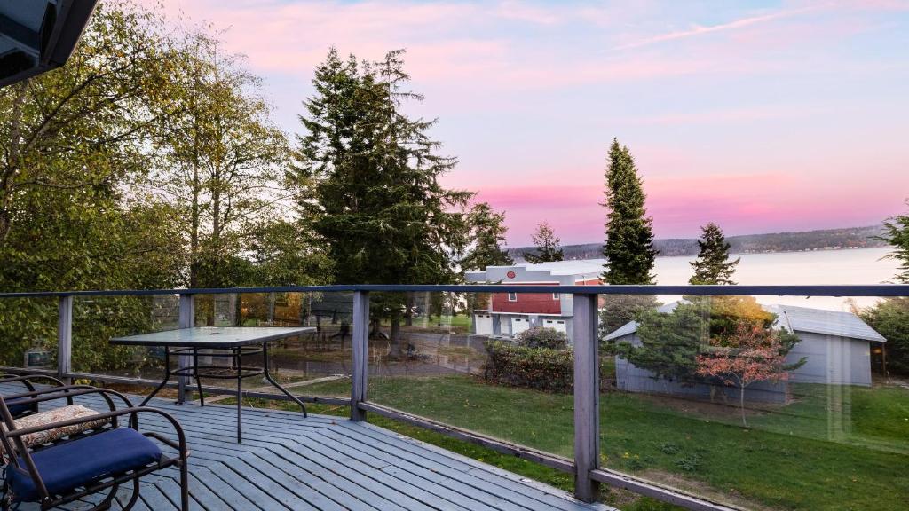 a balcony with a table and chairs on a deck at Incredible Water Views Deck Relaxing Retreat Greenbank Getaway by AvantStay in Greenbank