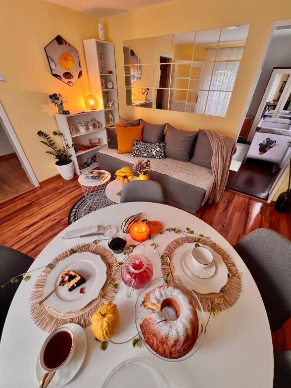 a living room with a table with food on it at Hidden Garden Aranđelovac in Arandelovac