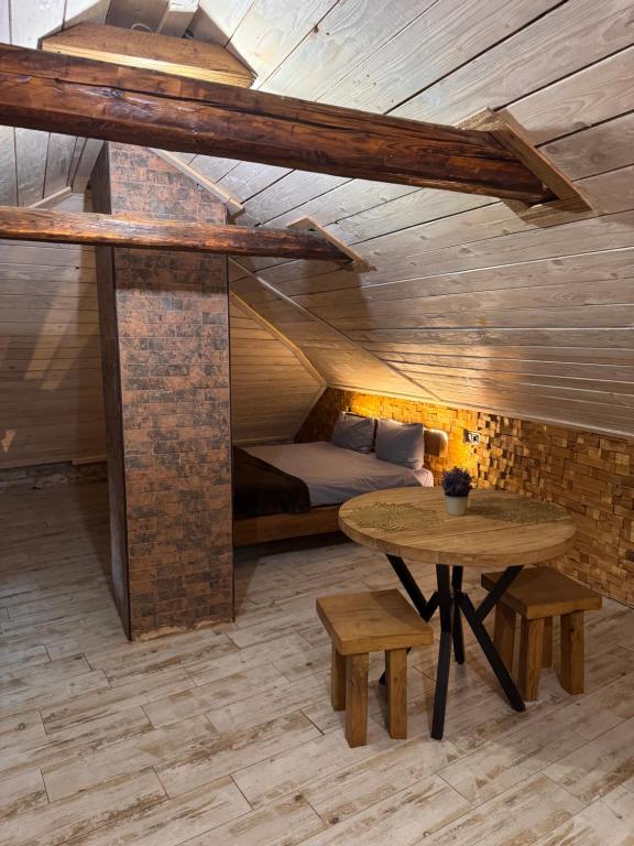 a room with a bed and a table in a room at Luxury Live in Kamianets-Podilskyi