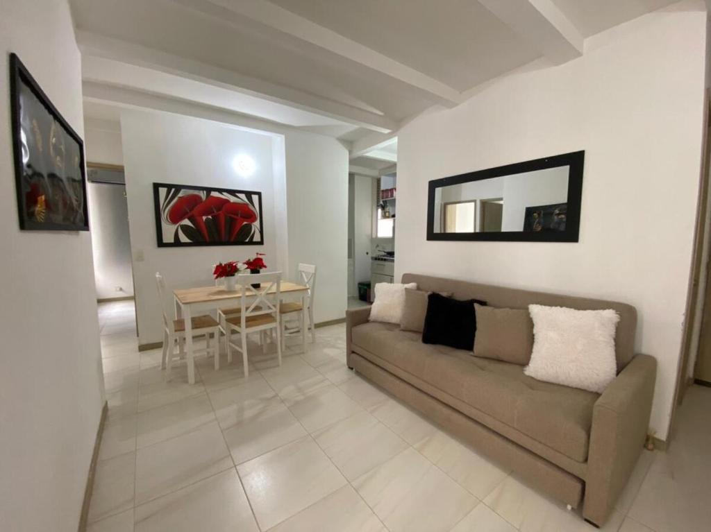 a living room with a couch and a table at Apartamento Playas de Marbella in Cartagena de Indias