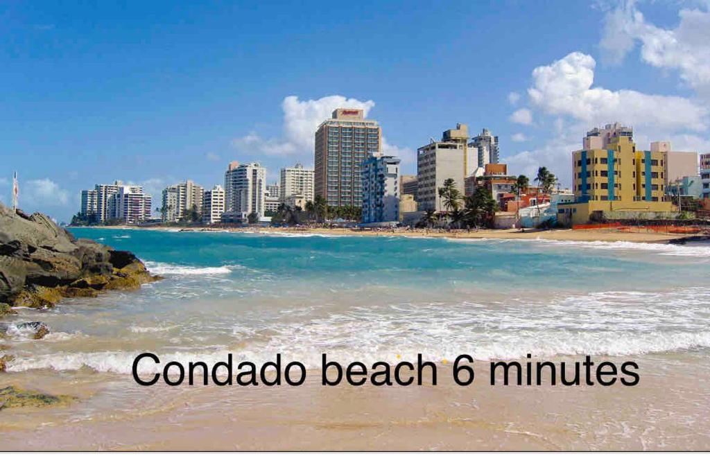 a beach in front of a city with buildings at Center of everything, art, beach and culture in santurce in San Juan