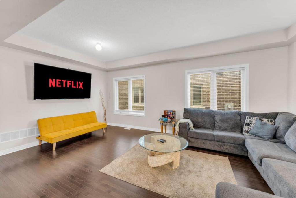 a living room with a couch and a table at Luxury Home Mins from Waterfall next to Transit in Niagara Falls