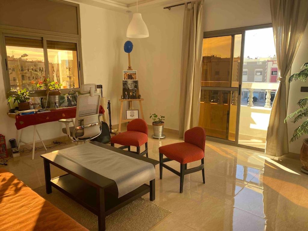 a living room with a bed and chairs and a piano at Apartment Private room in apartment in Khouribga in Khouribga