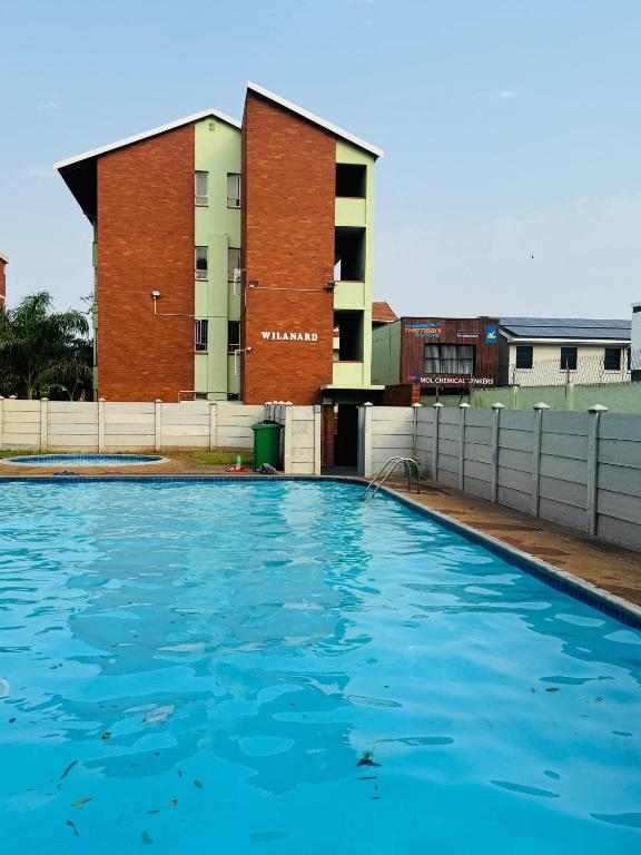 a swimming pool in front of a building at Davenport Durban in Durban