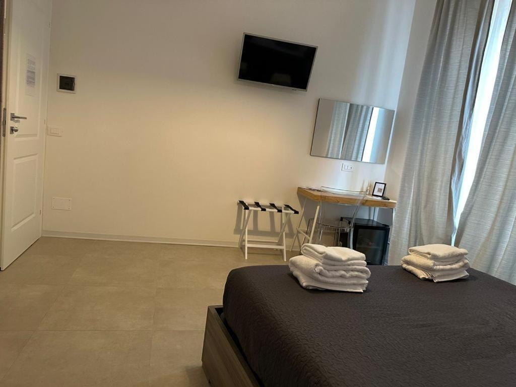 a bedroom with a bed with towels on top of it at Le camere al San Martino in La Spezia