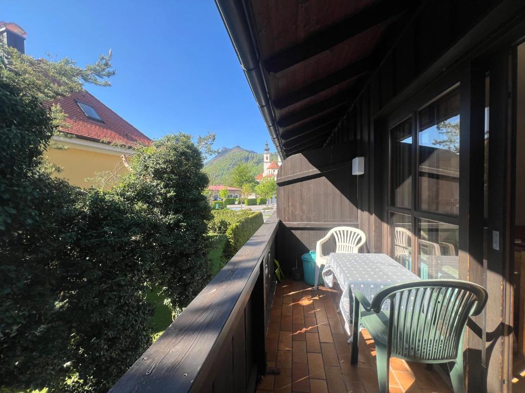 a patio with two chairs and a table on a building at ciao-aschau FeWo Fey in Aschau