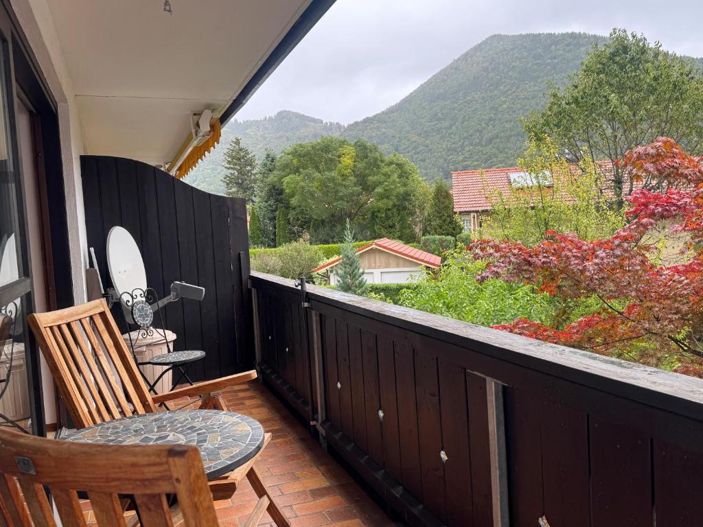 a balcony with two chairs and a view of a mountain at ciao-aschau FeWo Beckmann in Aschau