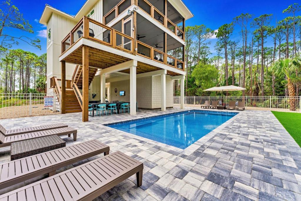 a home with a swimming pool and a house at Endless Summer St George 4Bed 3 5 Bath with POOL in St. George Island