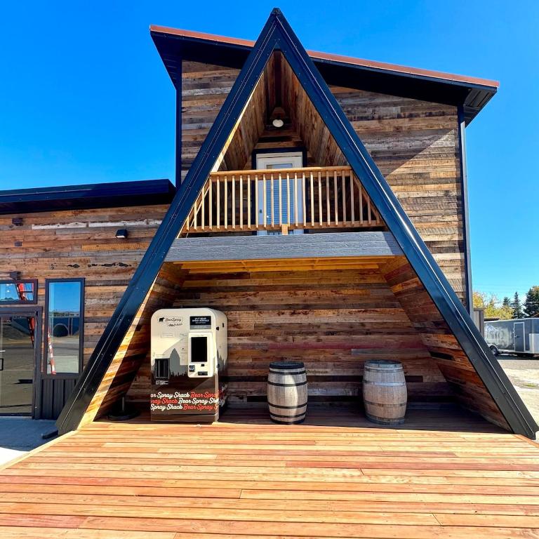 a house with a deck with a rv and barrels at Glacier Alpine Escape in East Glacier Park