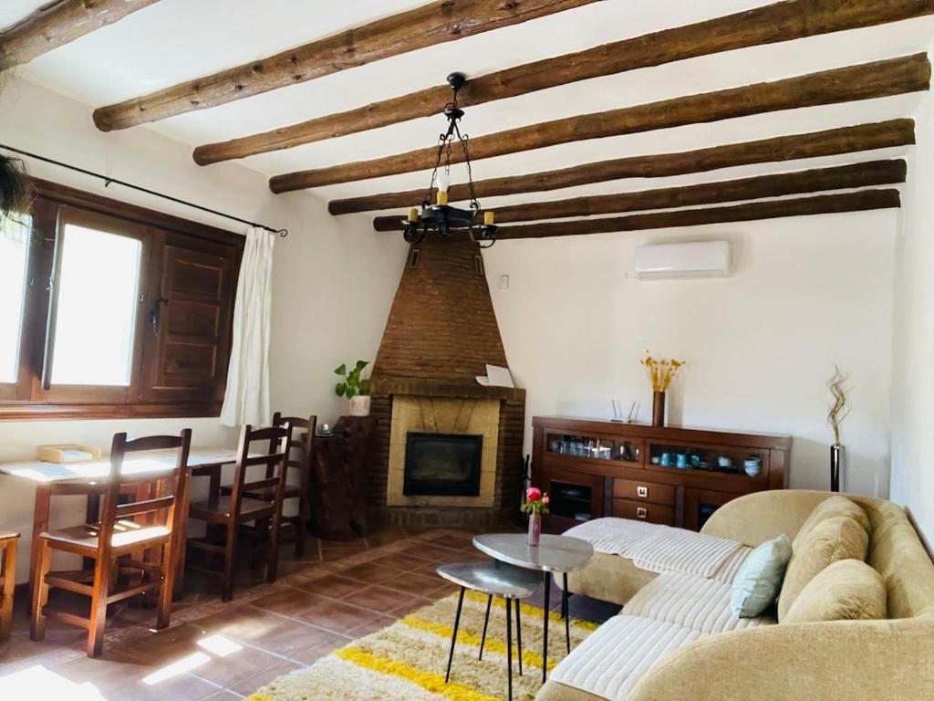 a living room with a couch and a fireplace at Beautiful villa in a Peaceful Haven in Órgiva