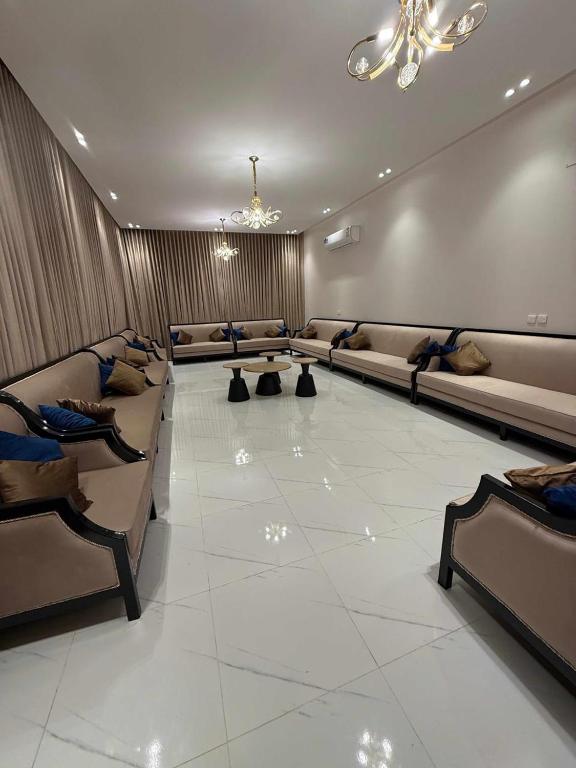 a large living room with couches and tables and a ceiling at دهم الرمك in Khamis Mushayt