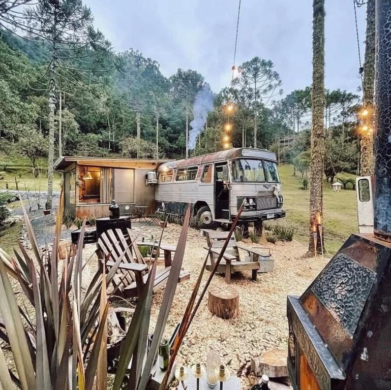 a bus parked in front of a tiny house at Green Valley Bus Cabin in Urubici