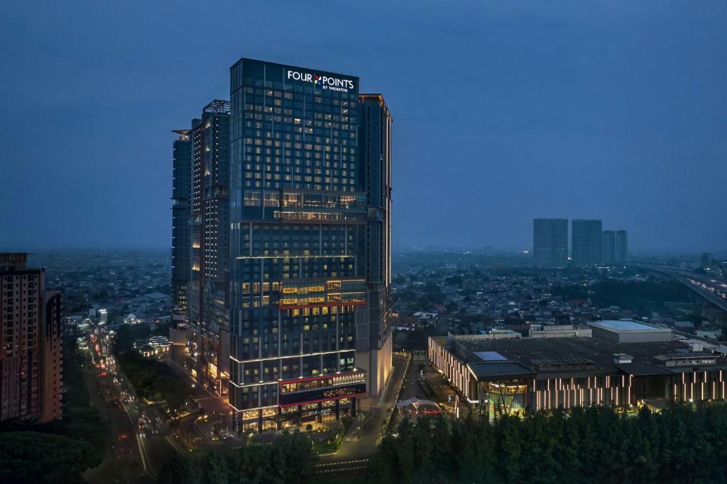 a tall building with a sign on top of it at Four Points by Sheraton Bekasi in Bekasi