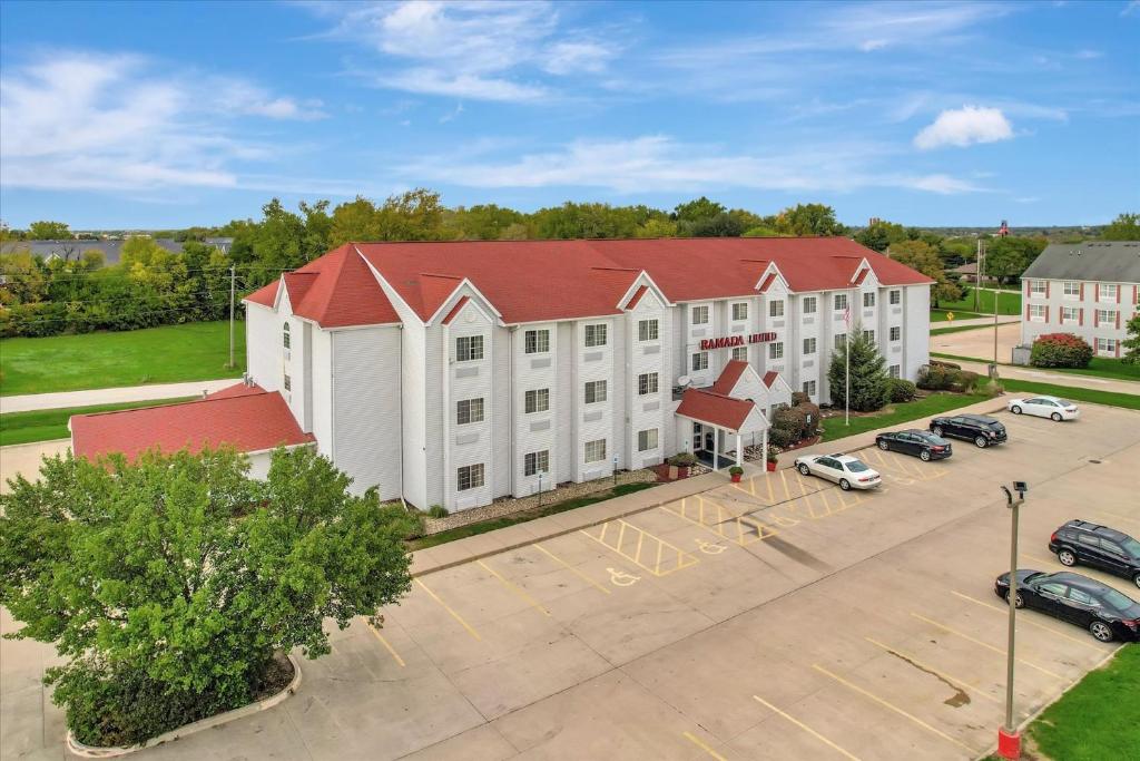an aerial view of a large white building with a red roof at Ramada Limited Bloomington IL I-74/I-55 in Bloomington