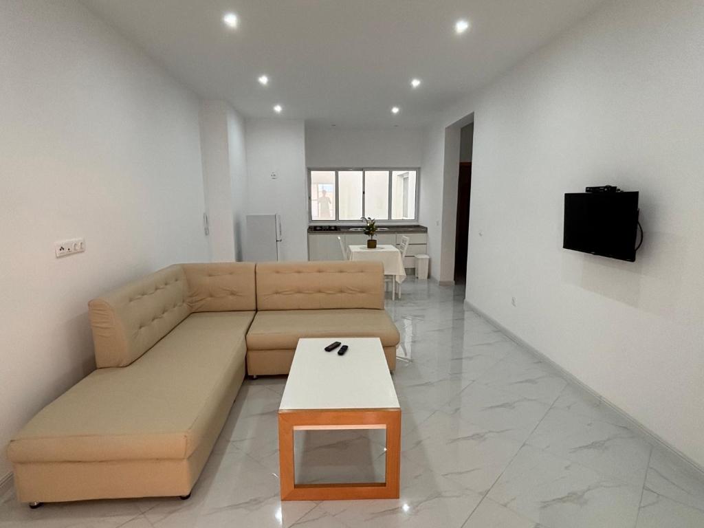 a living room with a couch and a table at GP Apartamentos in São Filipe