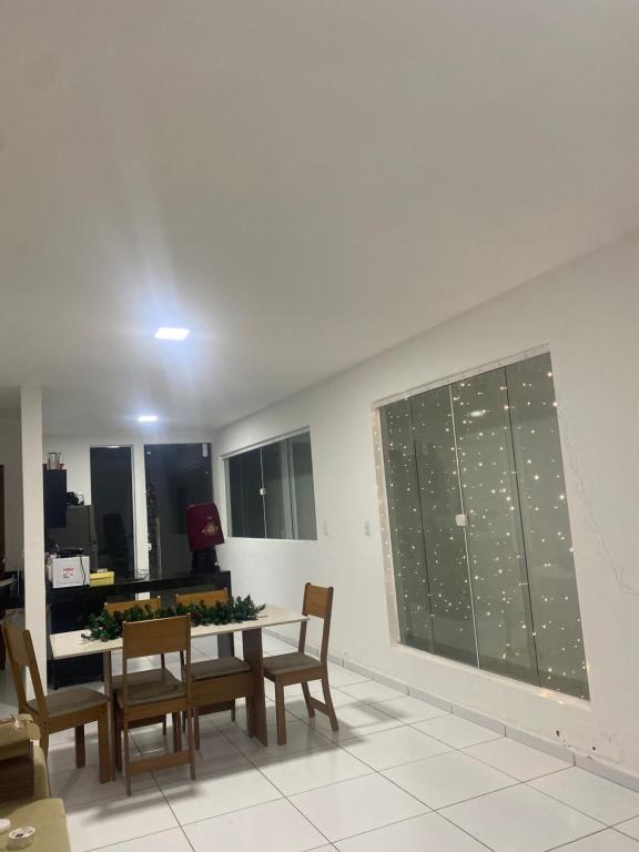 a classroom with a table and chairs and a chalkboard at Casa para o Natal perto do palco centro, 3 quarto in Garanhuns