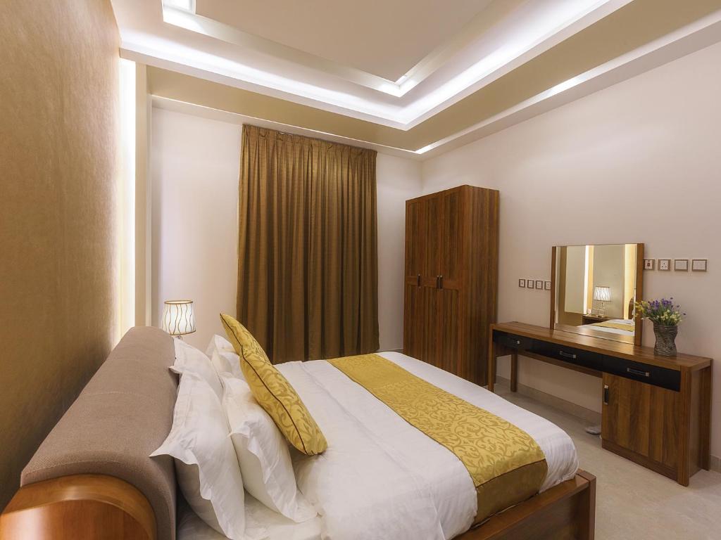 Postel nebo postele na pokoji v ubytování Mrfaaliah for Furnished Apartments مرفا عاليه للشقق المخدومة